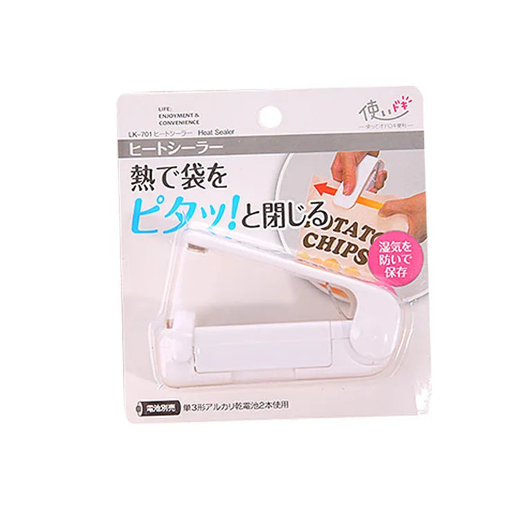 Household food clip portable mini plastic bag sealer heat sealing machine in pink on white background
