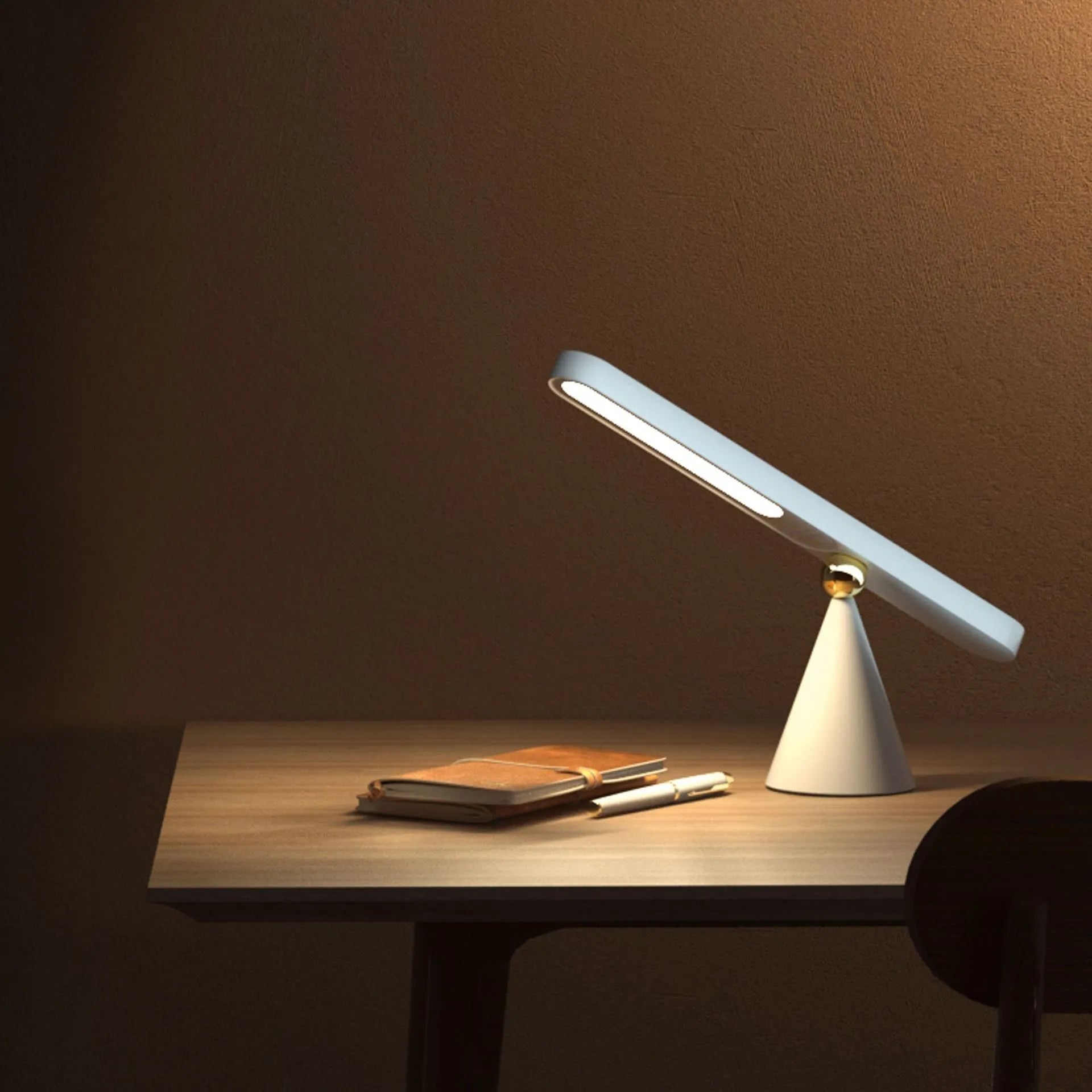 Geometric desk lamp with magnetic base shown in khaki colour with touch control