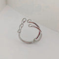 Brass opening ring with spherical element in gold finish on model finger