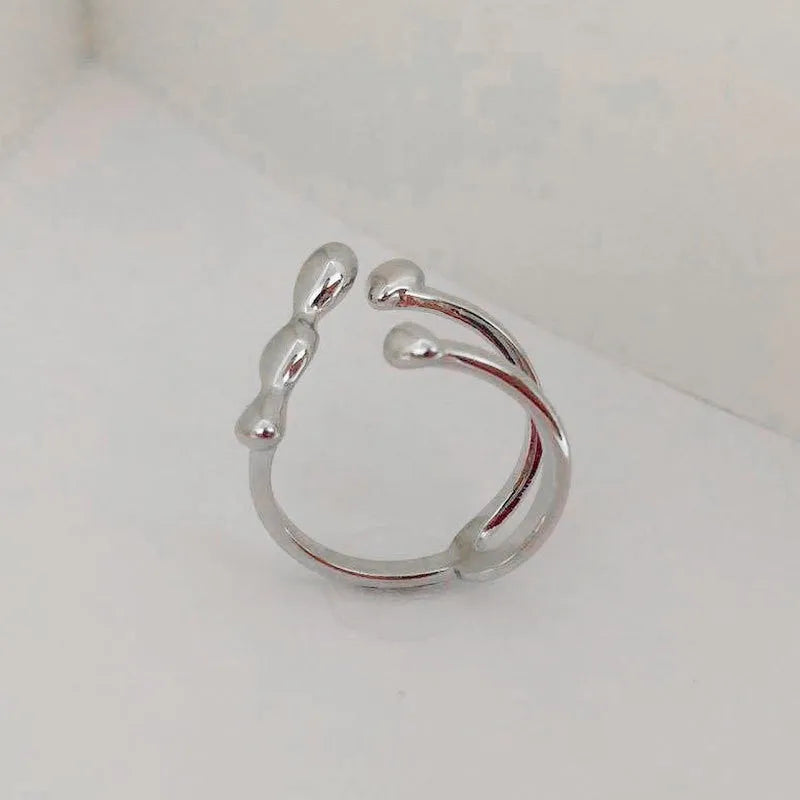 Brass opening ring with spherical element in gold finish on model finger