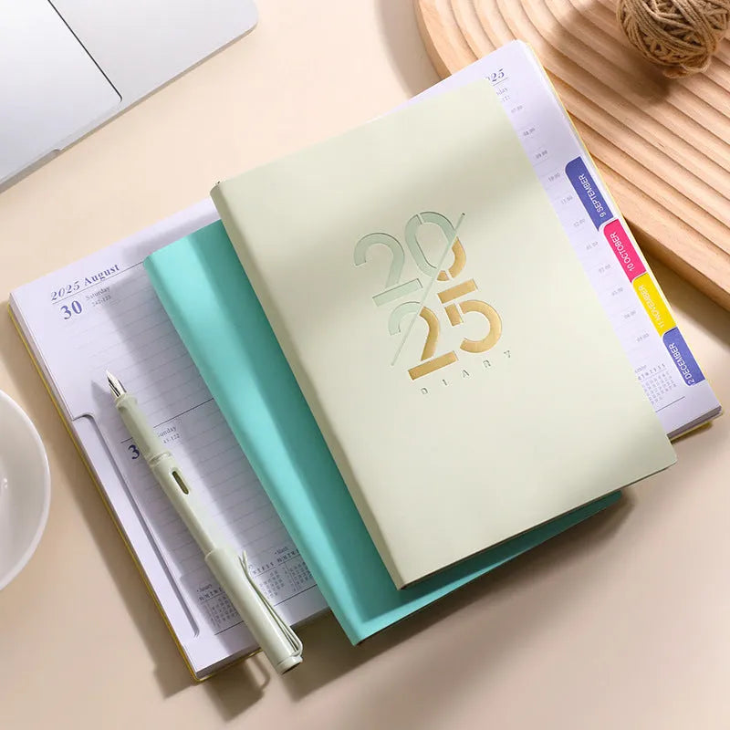 A5 2025 daily schedule book with faux leather cover in blue colour, open to show lined pages and thread binding.