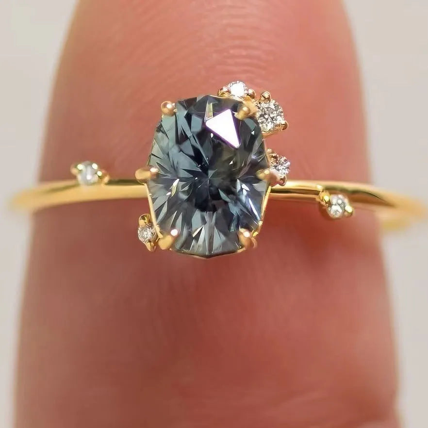 Gold plated alloy ring with floral design and green zircon stone, shown in various sizes