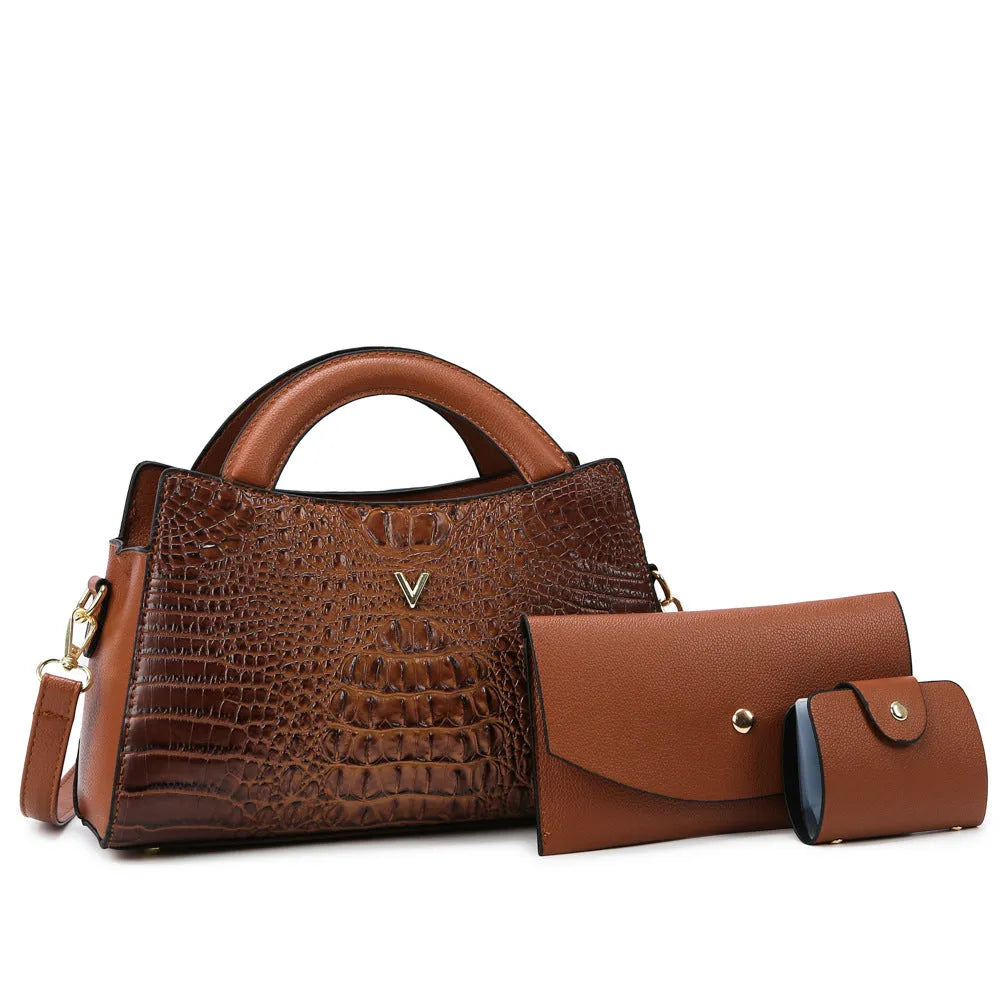 Square black women's crossbody bag with crocodile pattern texture and a single shoulder strap.