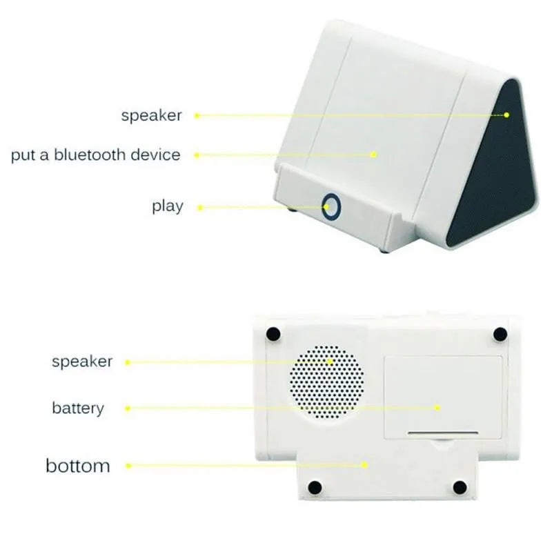Compact black and white wireless mini Bluetooth speaker with built-in charging cable.