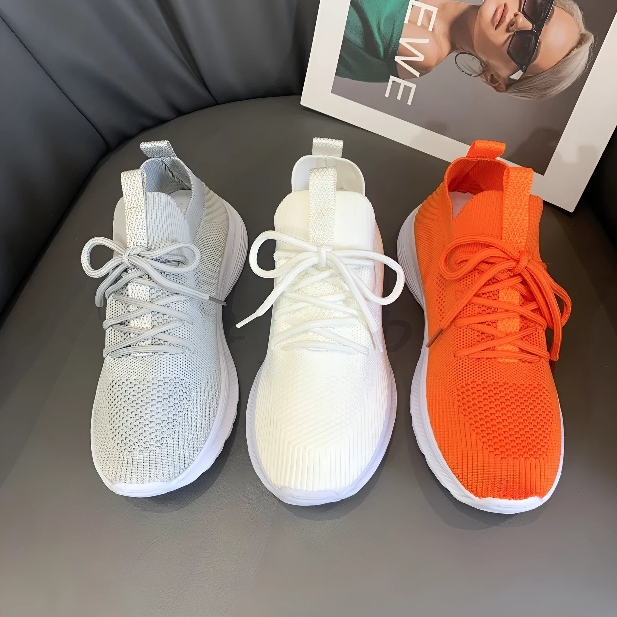Women's low-top running shoes in creamy white with Flyknit upper and flat rubber sole.