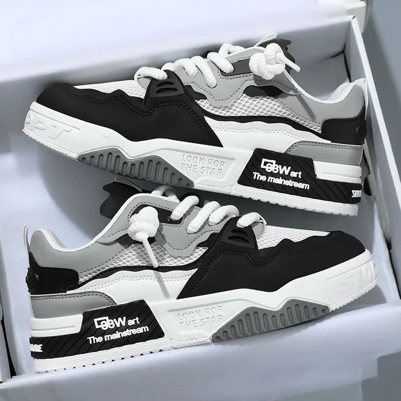 Men's white low-top board shoes with colour-matching accents on a soft rubber sole.