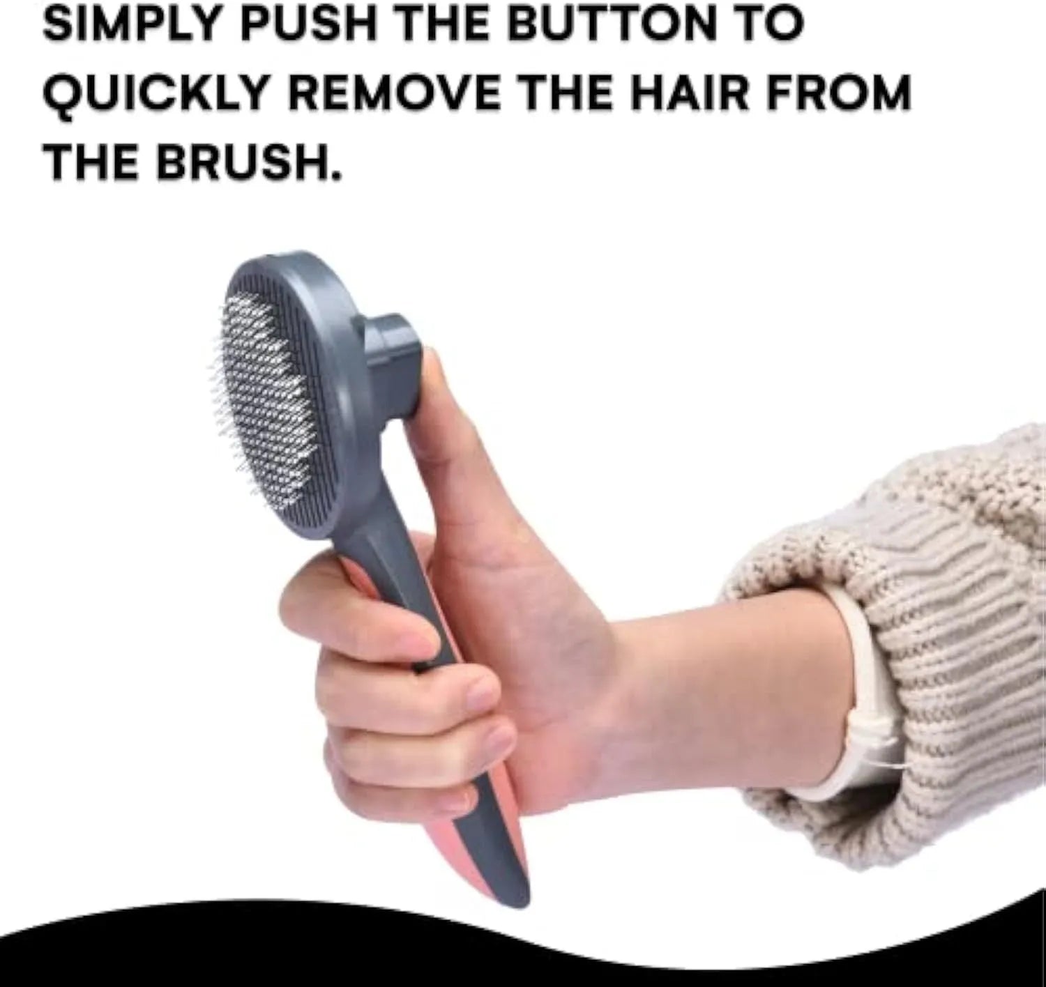 Grey self-cleaning slicker brush for pets with one-click button and comfort-grip handle on a table.