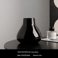 Ceramic decorative vase set with artificial orchid flowers in black or white coloured glaze finish