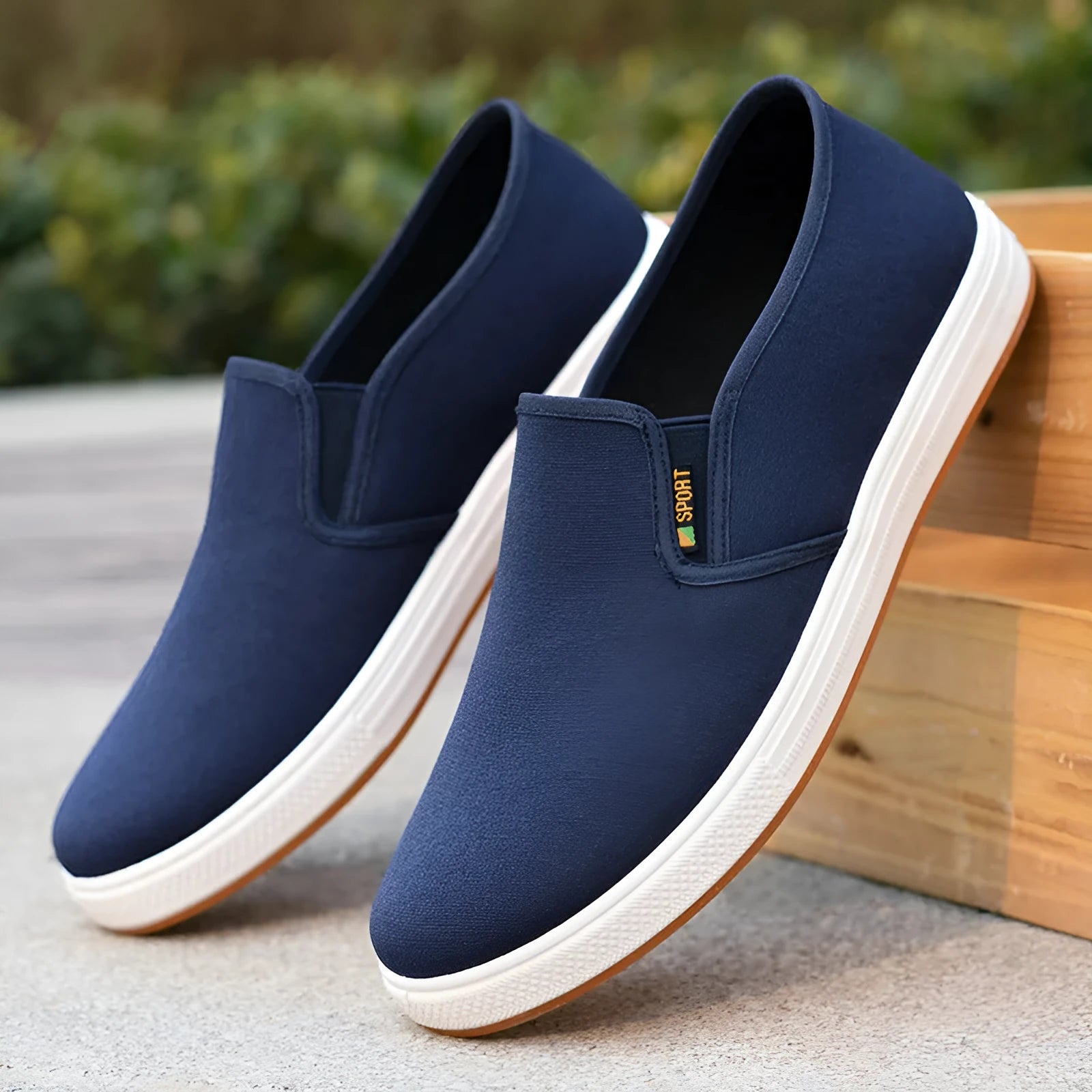 Men's low-top canvas slip-on shoes in blue colour showing round-toe design and composite soles