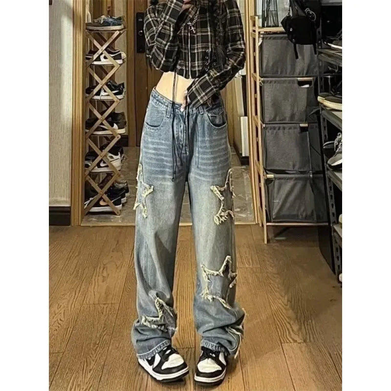 Blue high-waist wide-leg women's jeans on a model, showing the straight-leg cut and denim texture.