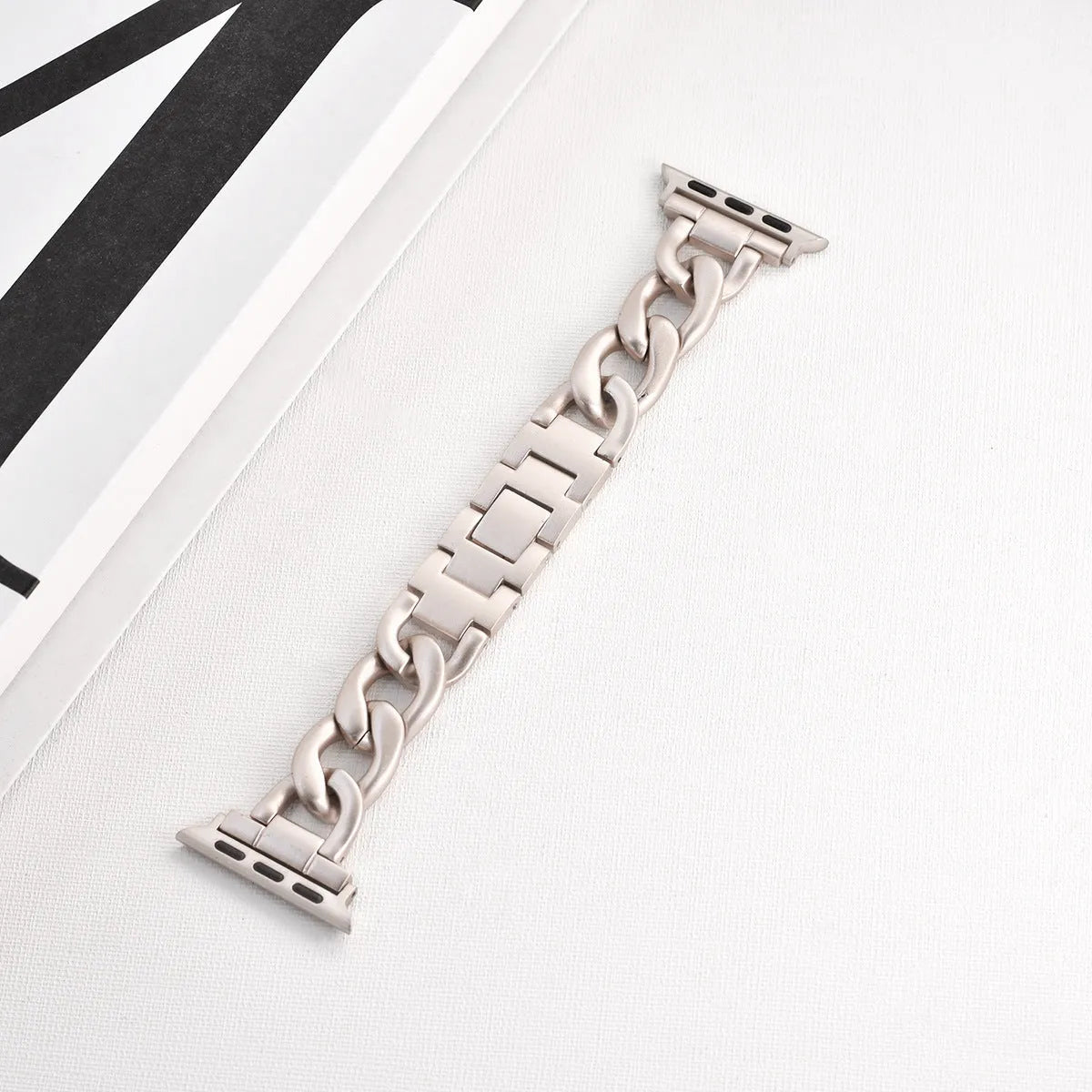 Metal chain link watch strap for Apple Watch in silver, black, gold, rose gold, or Starlight colour.