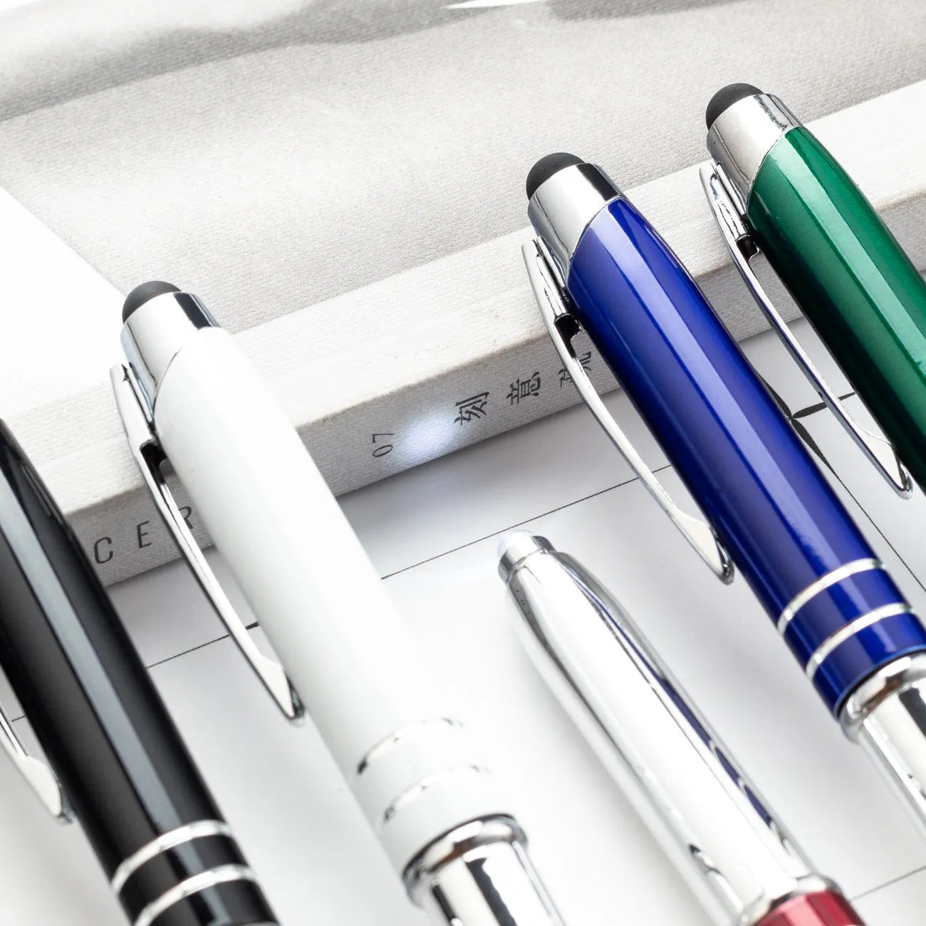 Red metal ballpoint pen with capacitive stylus tip and LED light, one of five colour options