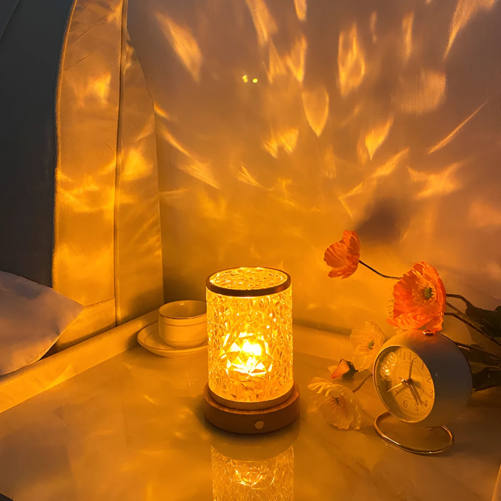 Rotating water ripple effect night light with acrylic body on a solid wood base.
