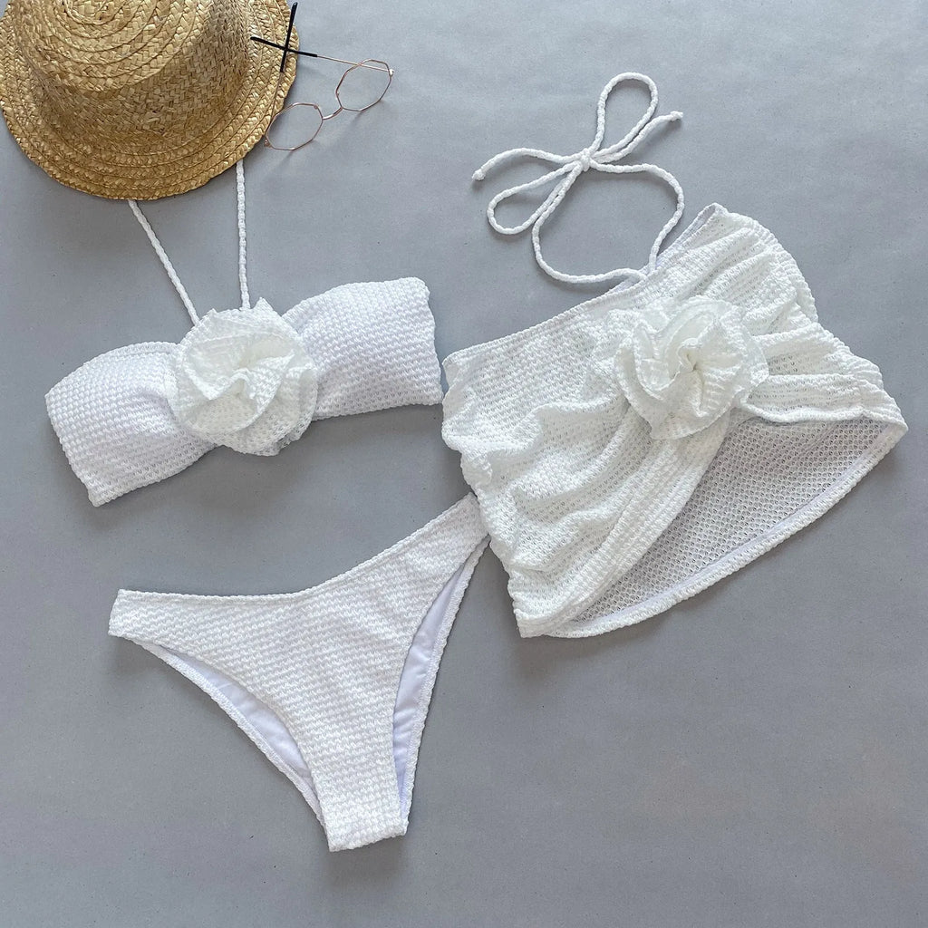 Women's purple and white 3D flower split bikini set with bra, panties, and skirt.