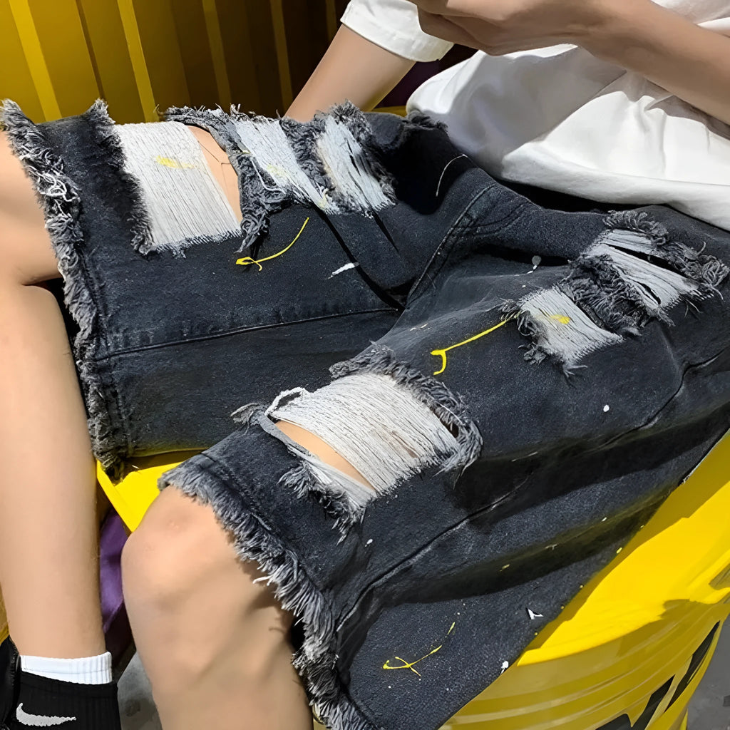 Men's loose-fit denim shorts with water washed hole detail in light blue colour.