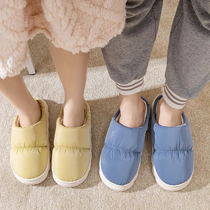 Blue winter house slippers with artificial leather upper, thick rubber sole, and plush lining on a wooden floor.