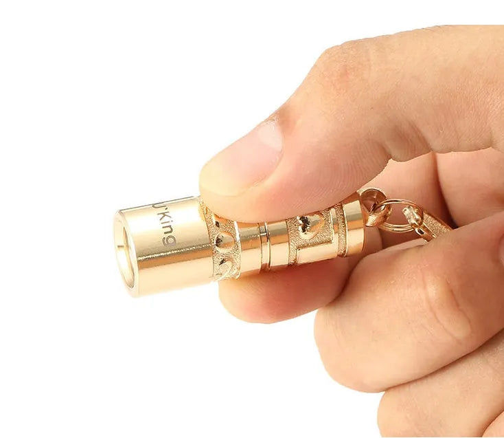 Gold zinc alloy waterproof LED flashlight keychain showing 7cm compact design