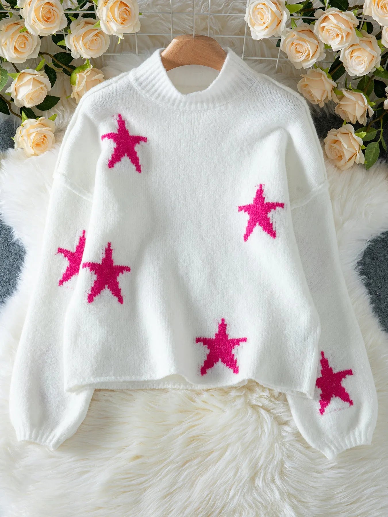 White women's loose turtleneck pullover sweater with a thick imitation velvet fabric and a contrast colour five-pointed star pattern.