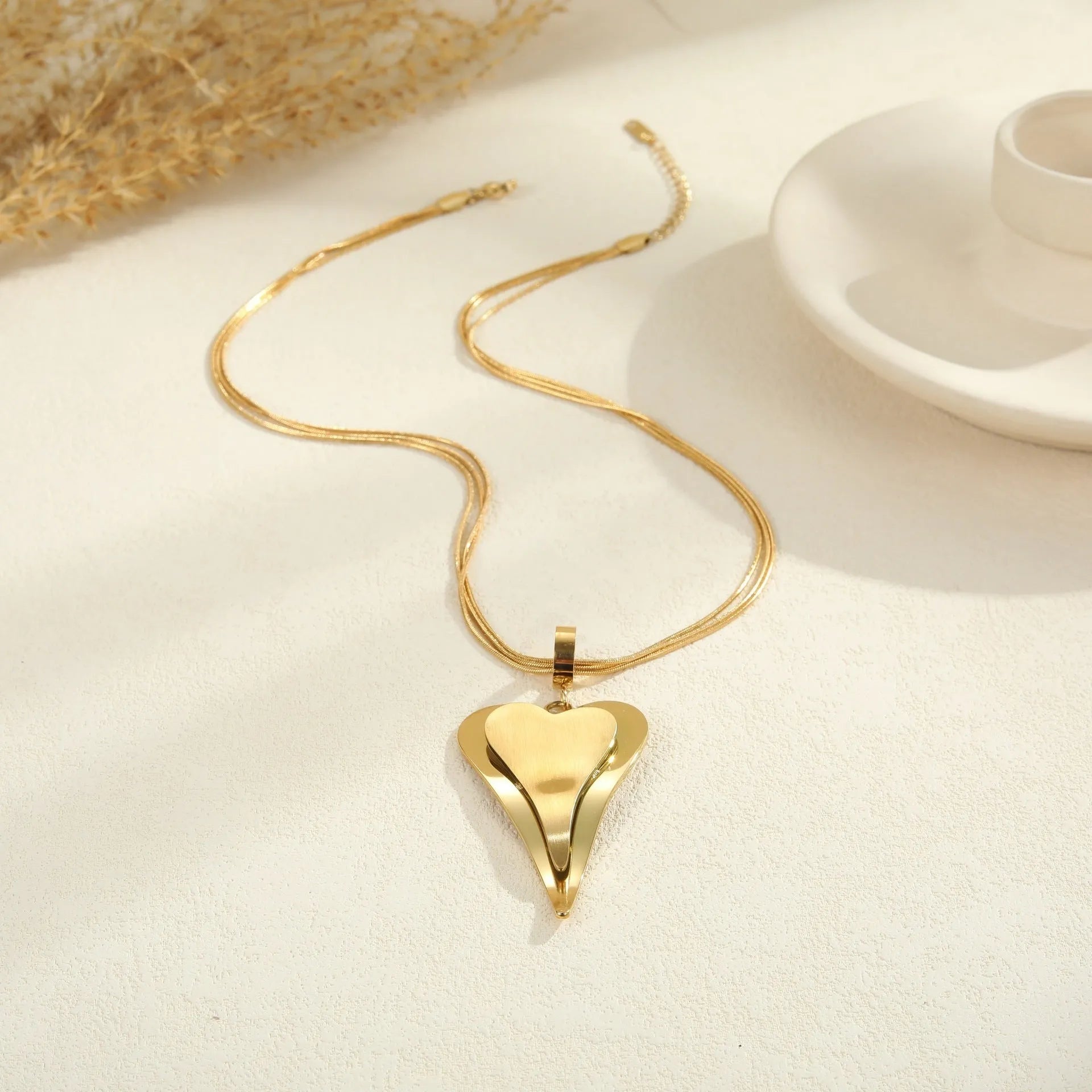 Double heart geometric pendant with snake bones chain design stainless steel necklace for women in gold or steel finish
