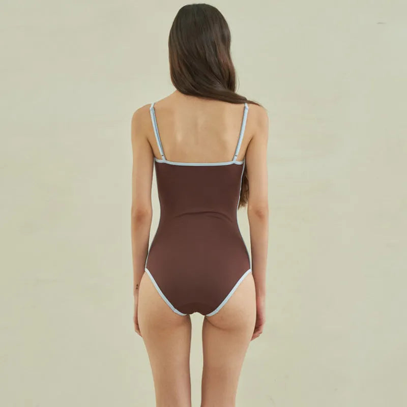 Brown women's one-piece swimsuit with triangle bust style on a mannequin.