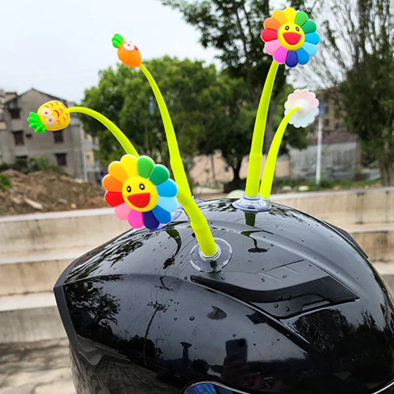 Yellow silicone sunflower helmet decoration with a suction cup mount on a helmet.