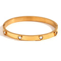 Golden electroplated stainless steel bracelet with a micro-inlaid peach heart charm for women.