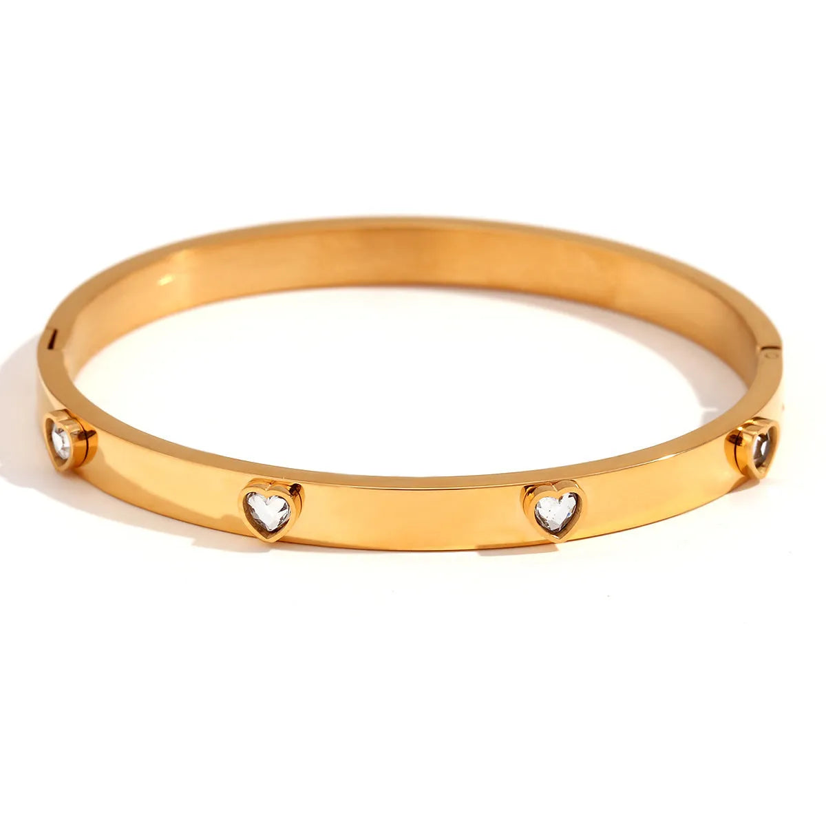 Golden electroplated stainless steel bracelet with a micro-inlaid peach heart charm for women.