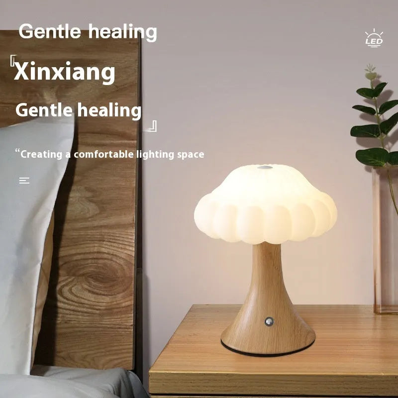 Mushroom-shaped touch control night lamp in wood grain colour on a table
