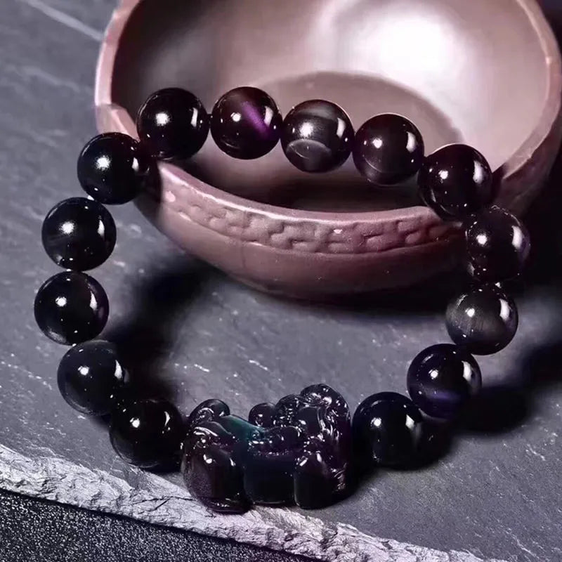 Natural ice colour eye obsidian crystal bracelet on wrist showing bead size.