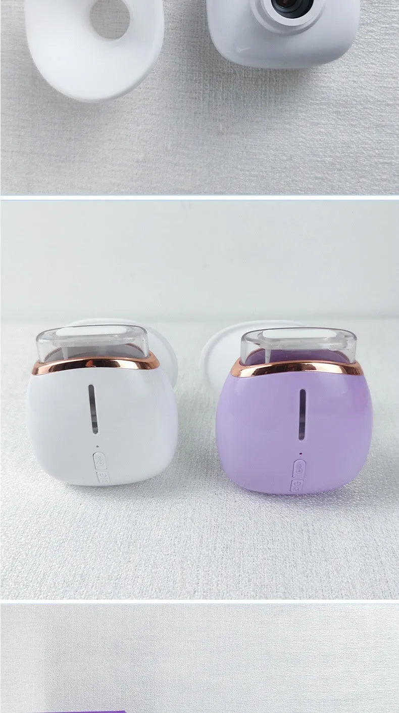 White and purple portable eye humidifier with USB charging cable on a desk