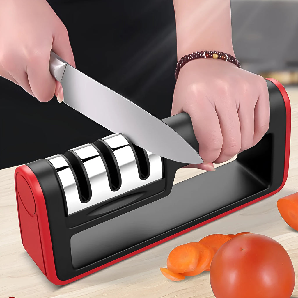 Black and red three-stage knife sharpener with non-skid rubber feet on a worktop