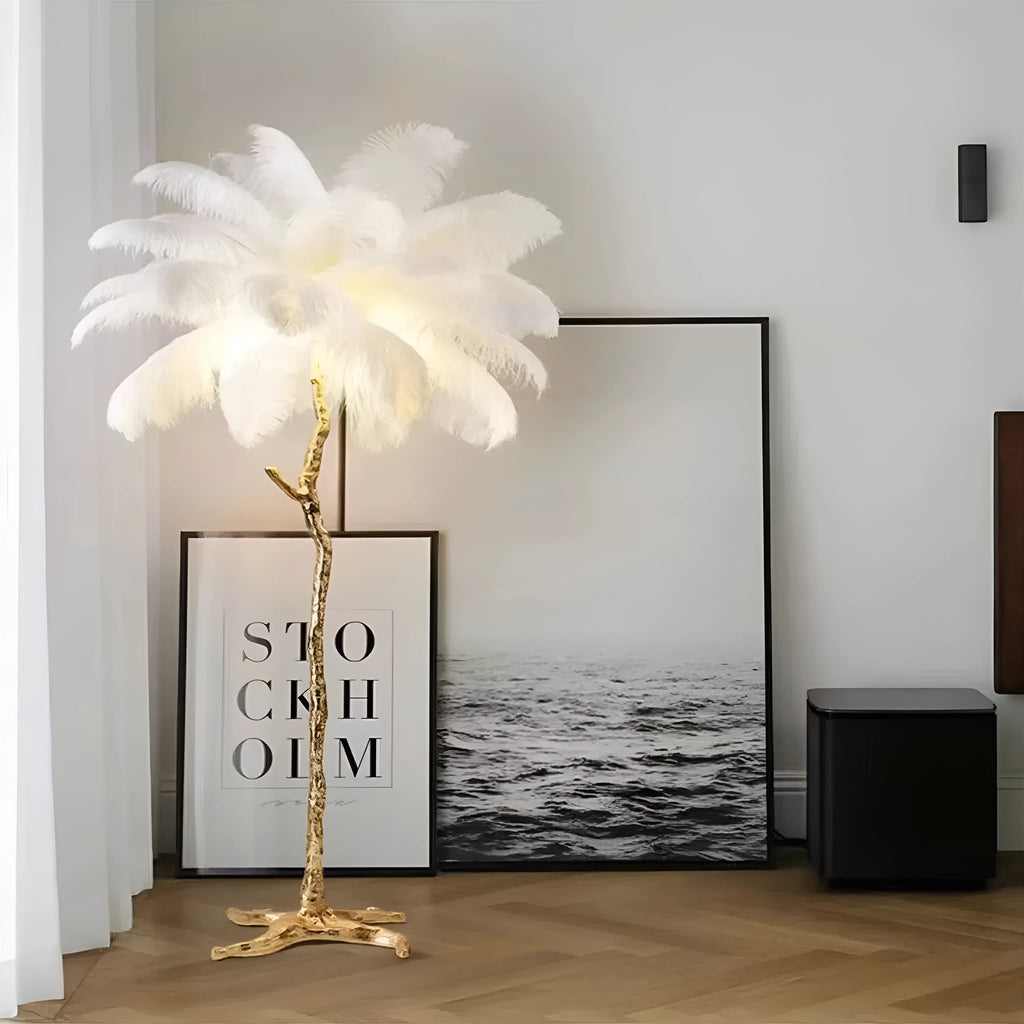 Tall decorative floor lamp with a cluster of white resin feathers next to a sofa.