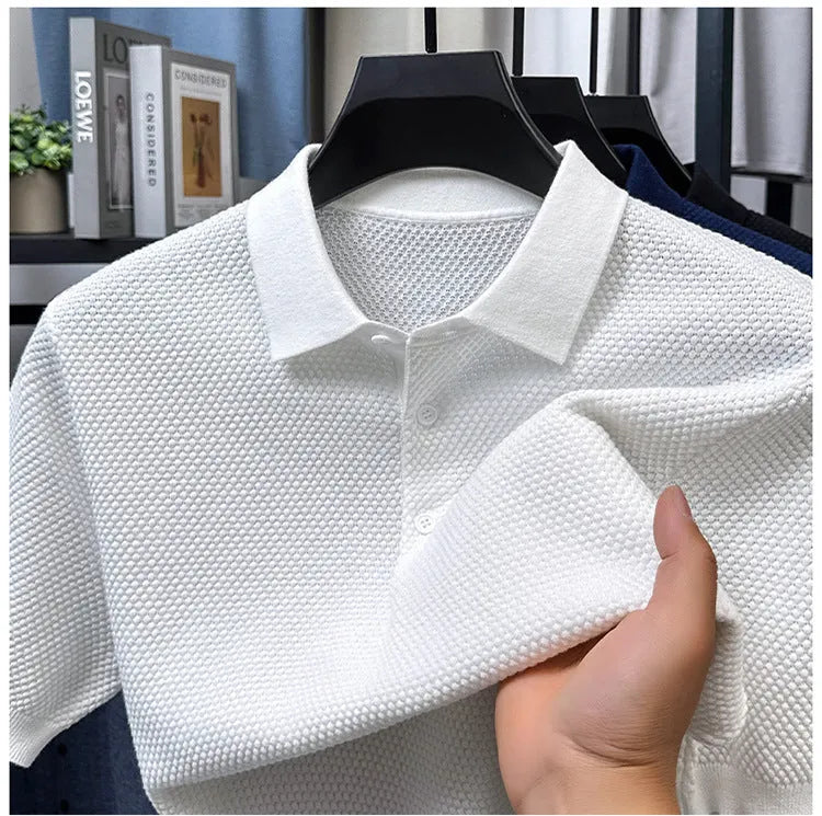 Man wearing a loose grey short sleeve cotton sweater, casual pullover style