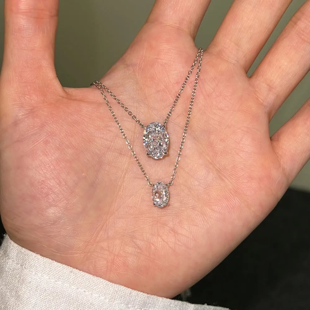 S925 sterling silver necklace with a geometric oval ice flower pendant, shown in gold and platinum finishes.