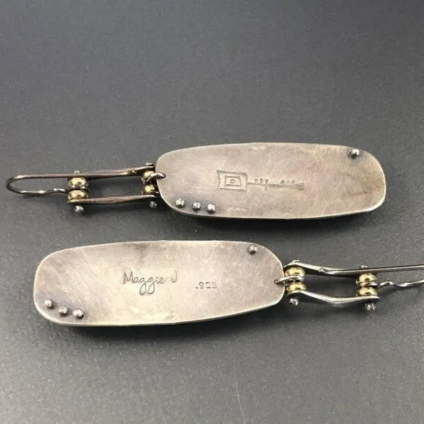 A pair of simple geometric alloy earrings with a two-tone marble pattern finish.