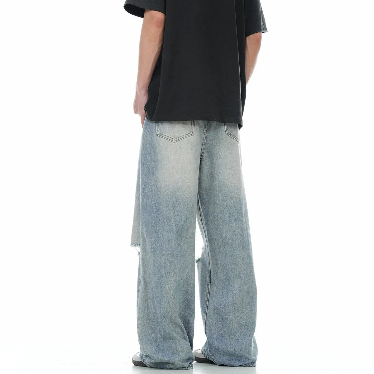 Blue men's straight-leg jeans with vintage rip detailing and zipper fly closure