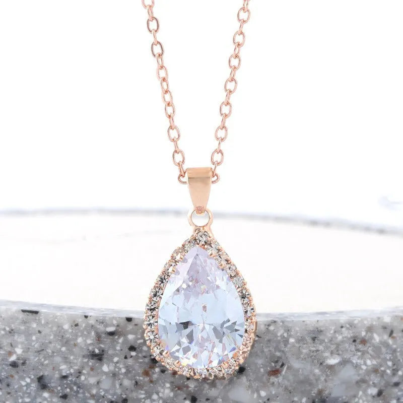Women's drop shape necklace with rhinestone inlay and geometric design in pink colour option