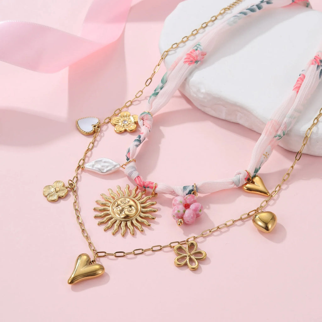 Gold plated stainless steel necklace with a geometric sun pendant on an adjustable chain.