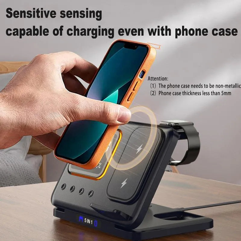 Black 5-in-1 wireless charging dock station showing phone, watch, and earbuds charging next to LED digital clock display.