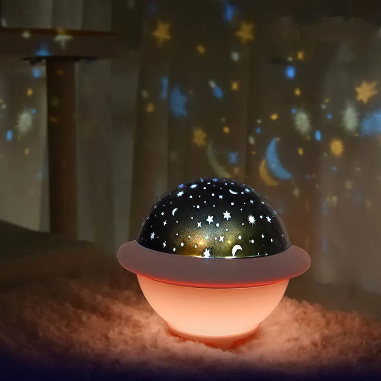 Green UFO-shaped LED star projector light showing rotating star projection on wall