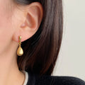 Copper teardrop drop pendant earrings in gold electroplated finish, pair of ear clips