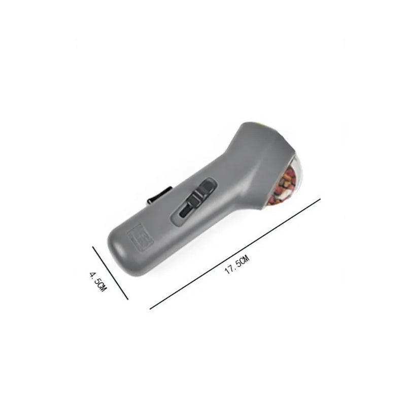 Grey dog treat catapult launcher measuring 18cm with spring trigger for 3 metre snack ejection