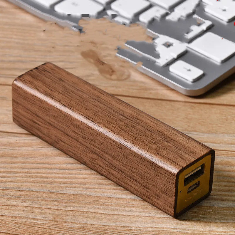 Portable black walnut solid wood power bank with 2000mAh 18650 battery, 100mm length, brown colour, on light background