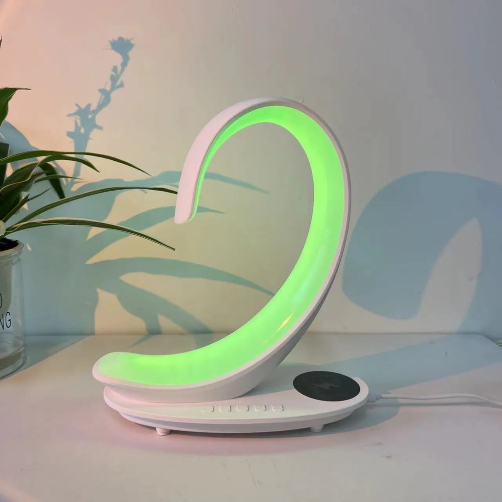 White swan-shaped desktop device with wireless charging surface, Bluetooth speaker, and colourful atmosphere lighting