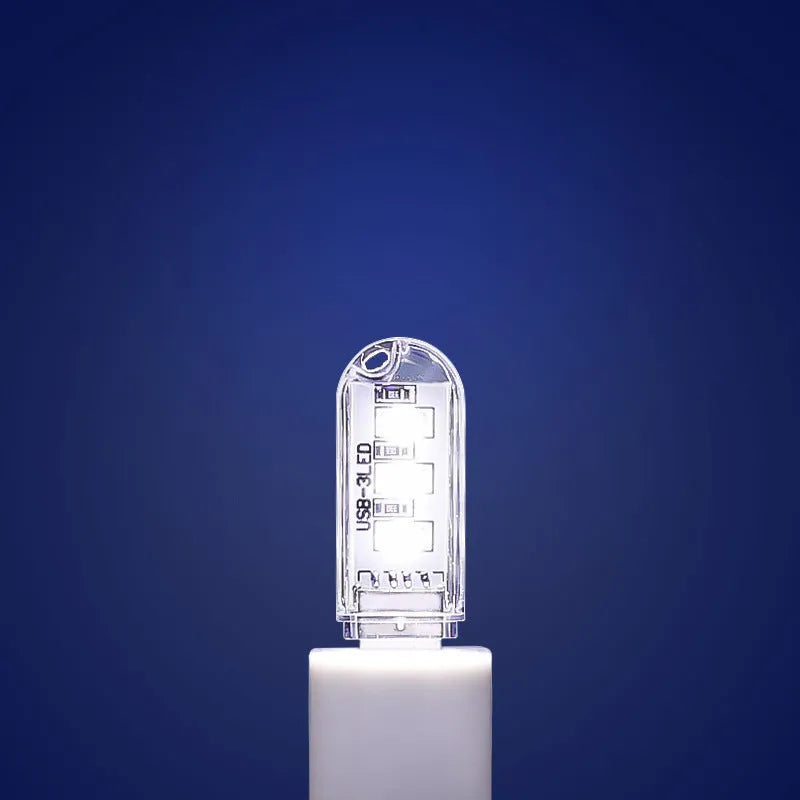 Compact LED night light with USB cable showing white and warm light colour options