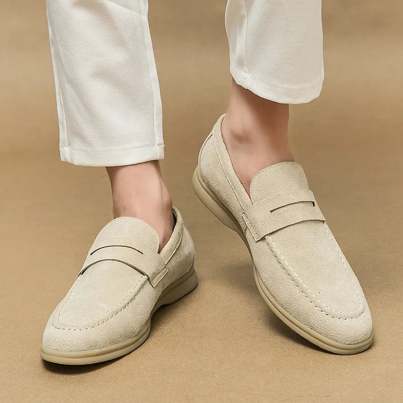 Men's black leather slip-on shoes with round toe and rubber soles shown from side view