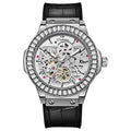Men's automatic skeleton watch with diamond details on movement, white shell case, and black dial.