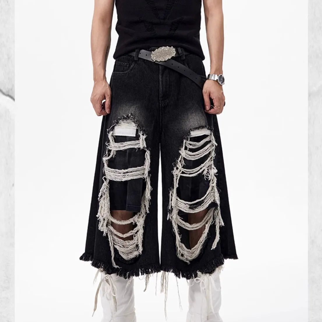 Black wide-leg cropped jeans with ripped patch detailing and mid-high waist