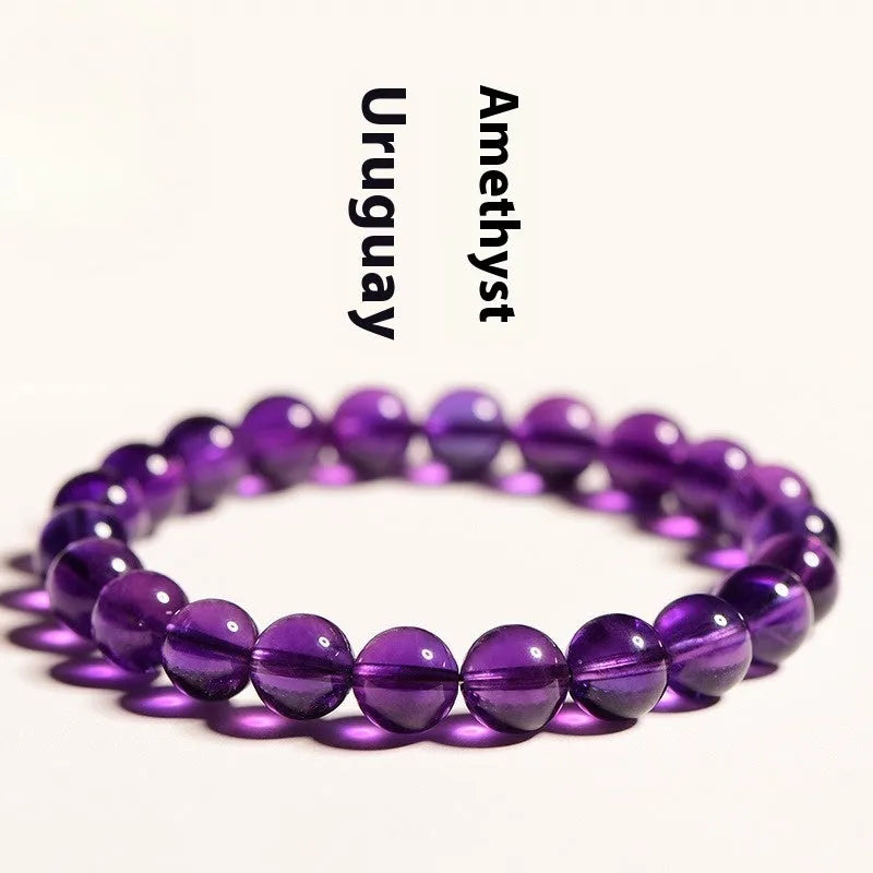 Natural Uruguayan amethyst crystal bracelet with round polished beads on a black stretch cord.