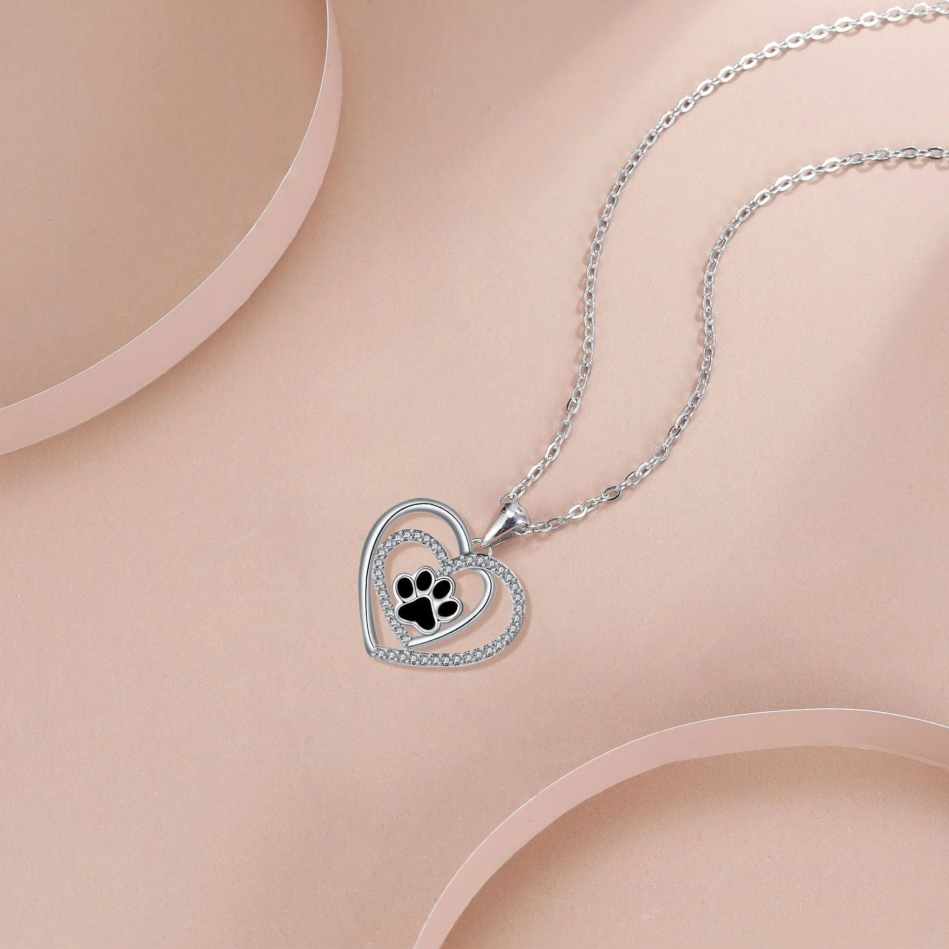 Electroplated copper necklace with heart-shaped dog paw print pendant on cross chain